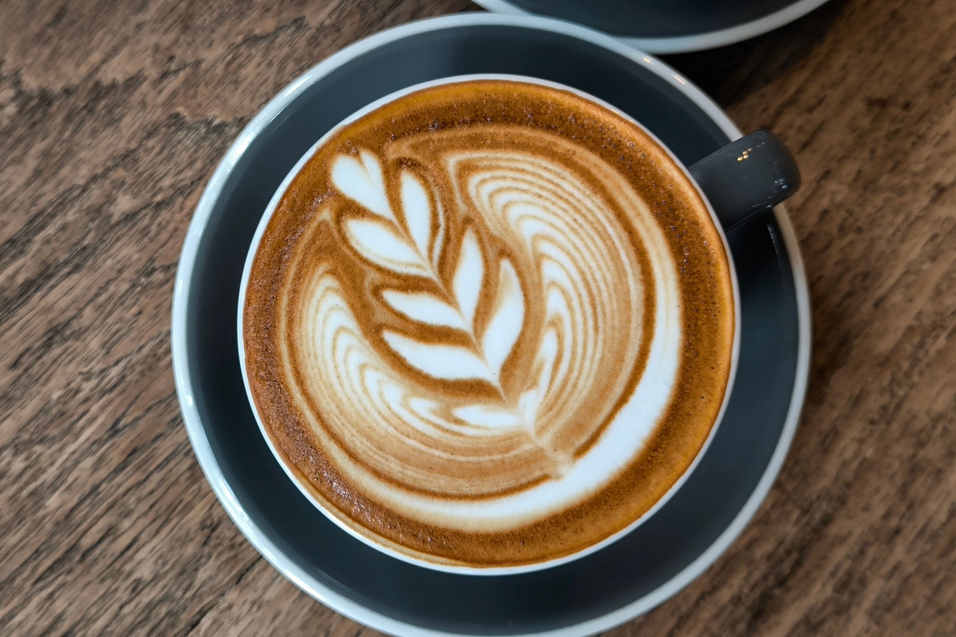 latte coffee cup on a wooden table The scene is cozy